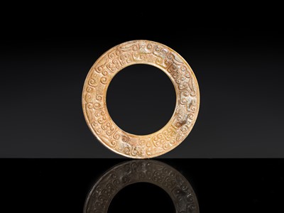 Lot 84 - A SMALL YELLOW JADE ‘DRAGONS’ RING, HUAN, EASTERN ZHOU, SPRING AND AUTUMN PERIOD