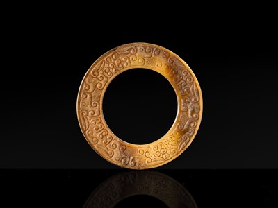 Lot 84 - A SMALL YELLOW JADE ‘DRAGONS’ RING, HUAN, EASTERN ZHOU, SPRING AND AUTUMN PERIOD