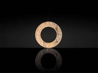 Lot 84 - A SMALL YELLOW JADE ‘DRAGONS’ RING, HUAN, EASTERN ZHOU, SPRING AND AUTUMN PERIOD