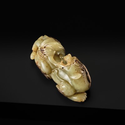 Lot 110 - A FINE CELADON AND BROWN JADE GROUP OF AN IMMORTAL RIDING A BIXIE, HAN DYNASTY