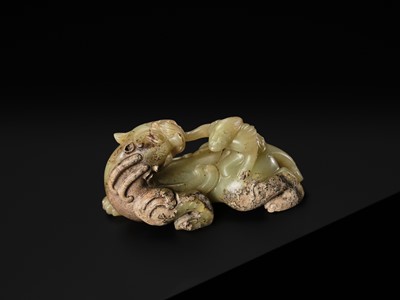 Lot 110 - A FINE CELADON AND BROWN JADE GROUP OF AN IMMORTAL RIDING A BIXIE, HAN DYNASTY
