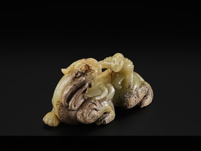 Lot 110 - A FINE CELADON AND BROWN JADE GROUP OF AN IMMORTAL RIDING A BIXIE, HAN DYNASTY