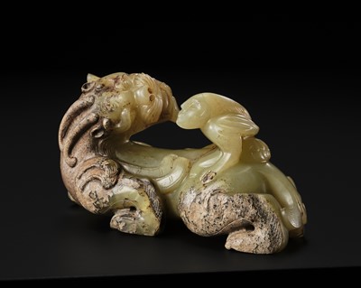 Lot 110 - A FINE CELADON AND BROWN JADE GROUP OF AN IMMORTAL RIDING A BIXIE, HAN DYNASTY
