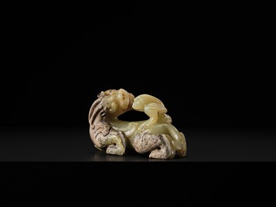 Lot 110 - A FINE CELADON AND BROWN JADE GROUP OF AN IMMORTAL RIDING A BIXIE, HAN DYNASTY