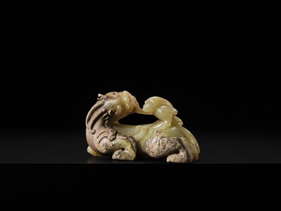 Lot 110 - A FINE CELADON AND BROWN JADE GROUP OF AN IMMORTAL RIDING A BIXIE, HAN DYNASTY