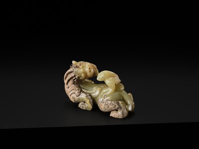 Lot 110 - A FINE CELADON AND BROWN JADE GROUP OF AN IMMORTAL RIDING A BIXIE, HAN DYNASTY
