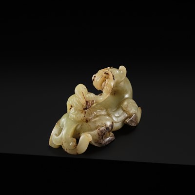 Lot 110 - A FINE CELADON AND BROWN JADE GROUP OF AN IMMORTAL RIDING A BIXIE, HAN DYNASTY