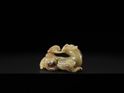 Lot 110 - A FINE CELADON AND BROWN JADE GROUP OF AN IMMORTAL RIDING A BIXIE, HAN DYNASTY