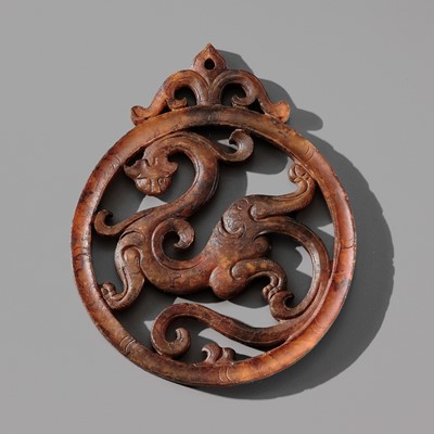 Lot 97 - A JADE OPENWORK DISC ‘DRAGON’ PENDANT, EARLY HAN DYNASTY