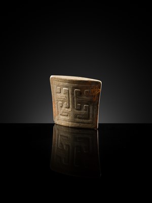 Lot 91 - A JADE ‘MASK’ SCABBARD CHAPE, WARRING STATES PERIOD TO HAN DYNASTY