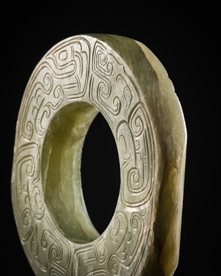Lot 88 - A GREEN JADE ‘DRAGONS AND BIRDS’ RING-FORM PENDANT, EASTERN ZHOU DYNASTY