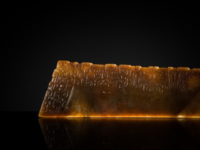 Lot 82 - A RARE BROWN JADE ‘ANIMAL MASK’ HARVESTING KNIFE, HU, SPRING AND AUTUMN PERIOD