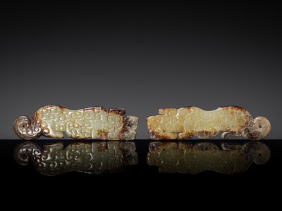 Lot 249 - A PAIR OF CELADON AND RUSSET JADE ‘TIGER’ PENDANTS, EASTERN ZHOU TO WARRING STATES