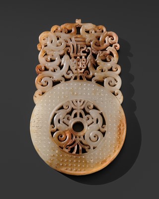 AN EXTREMELY RARE WHITE AND RUSSET JADE ‘INFINITE HAPINESS’ RETICULATED DISK (BI), HAN DYNASTY