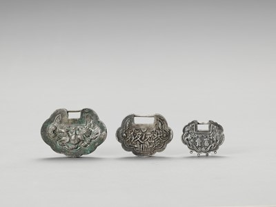 Lot 904 - TWO SILVER AND ONE SILVERED METAL LOCK CHARMS, LATE QING