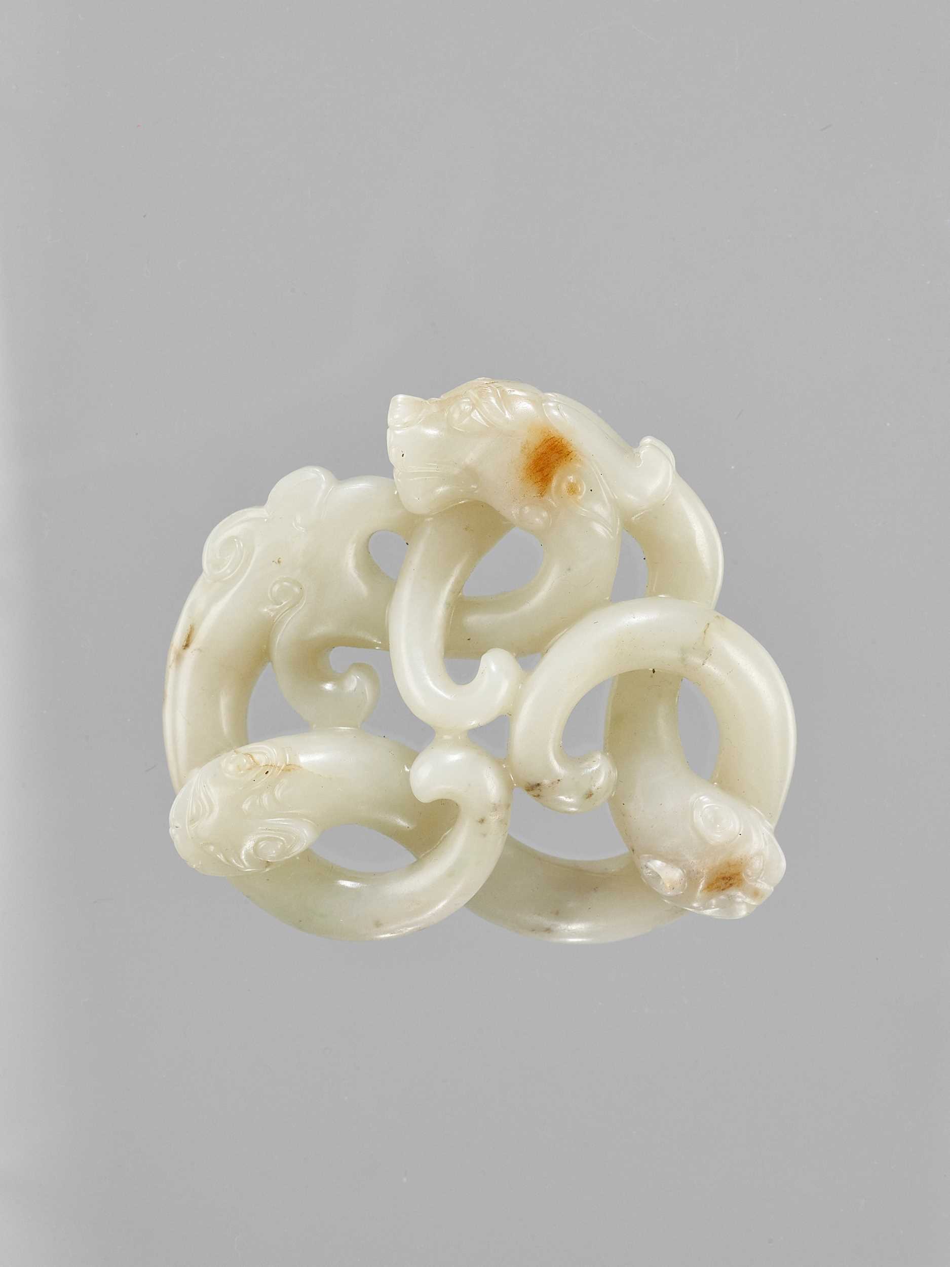 Lot 786 - A LARGE CELADON JADE CARVING OF THREE INTERTWINED DRAGONS, LATE QING TO REPUBLIC