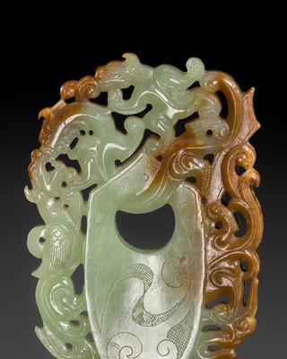 Lot 255 - AN OPENWORK PALE CELADON AND RUSSET ‘ARCHER’S RING AND BEASTS’ PENDANT, HAN DYNASTY