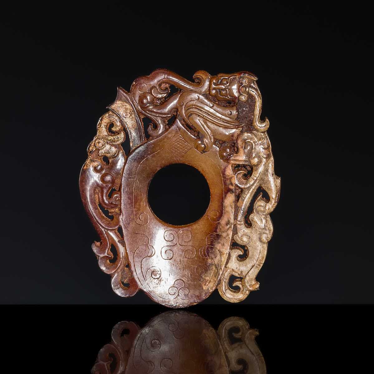 Lot 97 - A RUSSET JADE ‘CHILONG AND PHOENIX’ ARCHER’S RING PENDANT, SHE, HAN DYNASTY