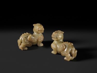 Lot 259 - A PAIR OF PALE CELADON AND BROWN JADE ‘BIXIE’ FIGURES, HAN DYNASTY