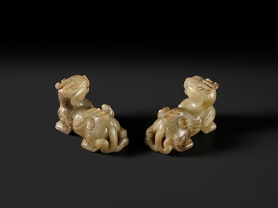 Lot 259 - A PAIR OF PALE CELADON AND BROWN JADE ‘BIXIE’ FIGURES, HAN DYNASTY