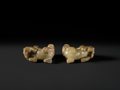 Lot 259 - A PAIR OF PALE CELADON AND BROWN JADE ‘BIXIE’ FIGURES, HAN DYNASTY