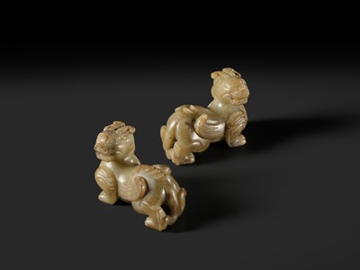 Lot 259 - A PAIR OF PALE CELADON AND BROWN JADE ‘BIXIE’ FIGURES, HAN DYNASTY