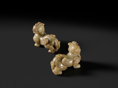 Lot 259 - A PAIR OF PALE CELADON AND BROWN JADE ‘BIXIE’ FIGURES, HAN DYNASTY