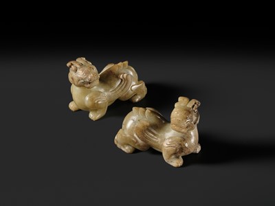 Lot 259 - A PAIR OF PALE CELADON AND BROWN JADE ‘BIXIE’ FIGURES, HAN DYNASTY