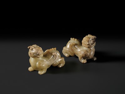 Lot 259 - A PAIR OF PALE CELADON AND BROWN JADE ‘BIXIE’ FIGURES, HAN DYNASTY