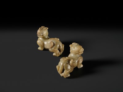 Lot 259 - A PAIR OF PALE CELADON AND BROWN JADE ‘BIXIE’ FIGURES, HAN DYNASTY