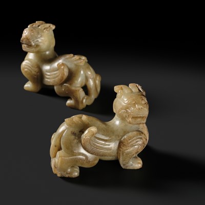 Lot 259 - A PAIR OF PALE CELADON AND BROWN JADE ‘BIXIE’ FIGURES, HAN DYNASTY