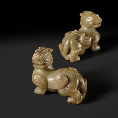 Lot 259 - A PAIR OF PALE CELADON AND BROWN JADE ‘BIXIE’ FIGURES, HAN DYNASTY