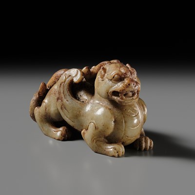 AN EXTRAORDINARY PALE CELADON AND RUSSET JADE FIGURE OF A BIXIE, HAN DYNASTY