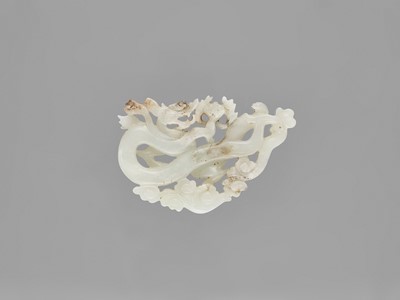 Lot 782 - A WHITE JADE ‘DRAGON’ PENDANT, LATE QING TO REPUBLIC
