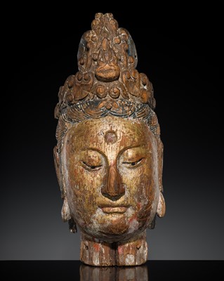Lot 252 - A LARGE GLASS-INLAID AND GILT-LACQUERED WOOD HEAD OF GUANYIN, QING DYNASTY OR EARLIER