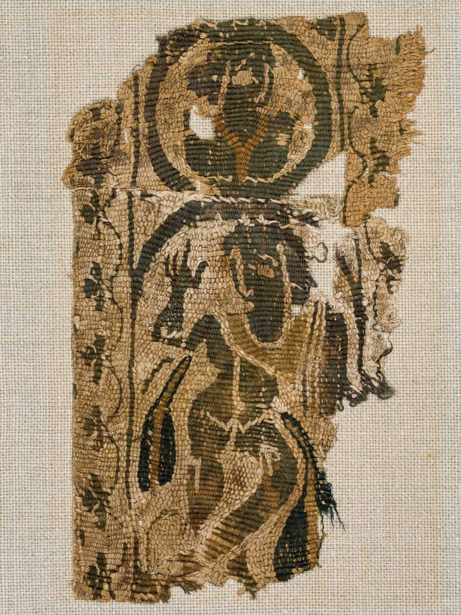 Lot 21 - A FRAGMENT OF A COPTIC TEXTILE WITH A MAENAD, EARLY BYZANTINE PERIOD, CIRCA 4TH-6TH CENTURY