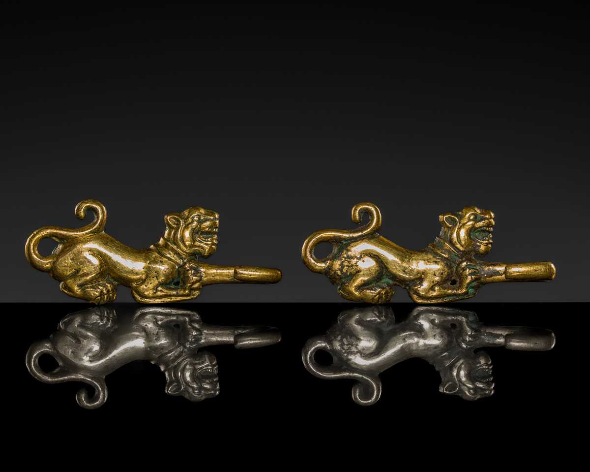 Lot 43 - A RARE PAIR OF GILT-BRONZE ‘TIGER’ GARMENT HOOKS, WESTERN HAN DYNASTY