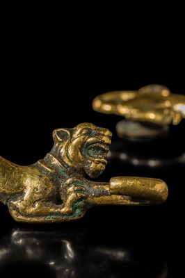 Lot 43 - A RARE PAIR OF GILT-BRONZE ‘TIGER’ GARMENT HOOKS, WESTERN HAN DYNASTY