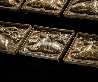 Lot 49 - A SET OF TEN GILT AND SILVERED COPPER REPOUSSÉ BELT PLAQUES, TANG TO LIAO DYNASTY