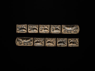 Lot 49 - A SET OF TEN GILT AND SILVERED COPPER REPOUSSÉ BELT PLAQUES, TANG TO LIAO DYNASTY