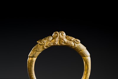 Lot 199 - A GILT-BRONZE ‘MAKARA’ BANGLE, SHOUZHUO, QING DYNASTY