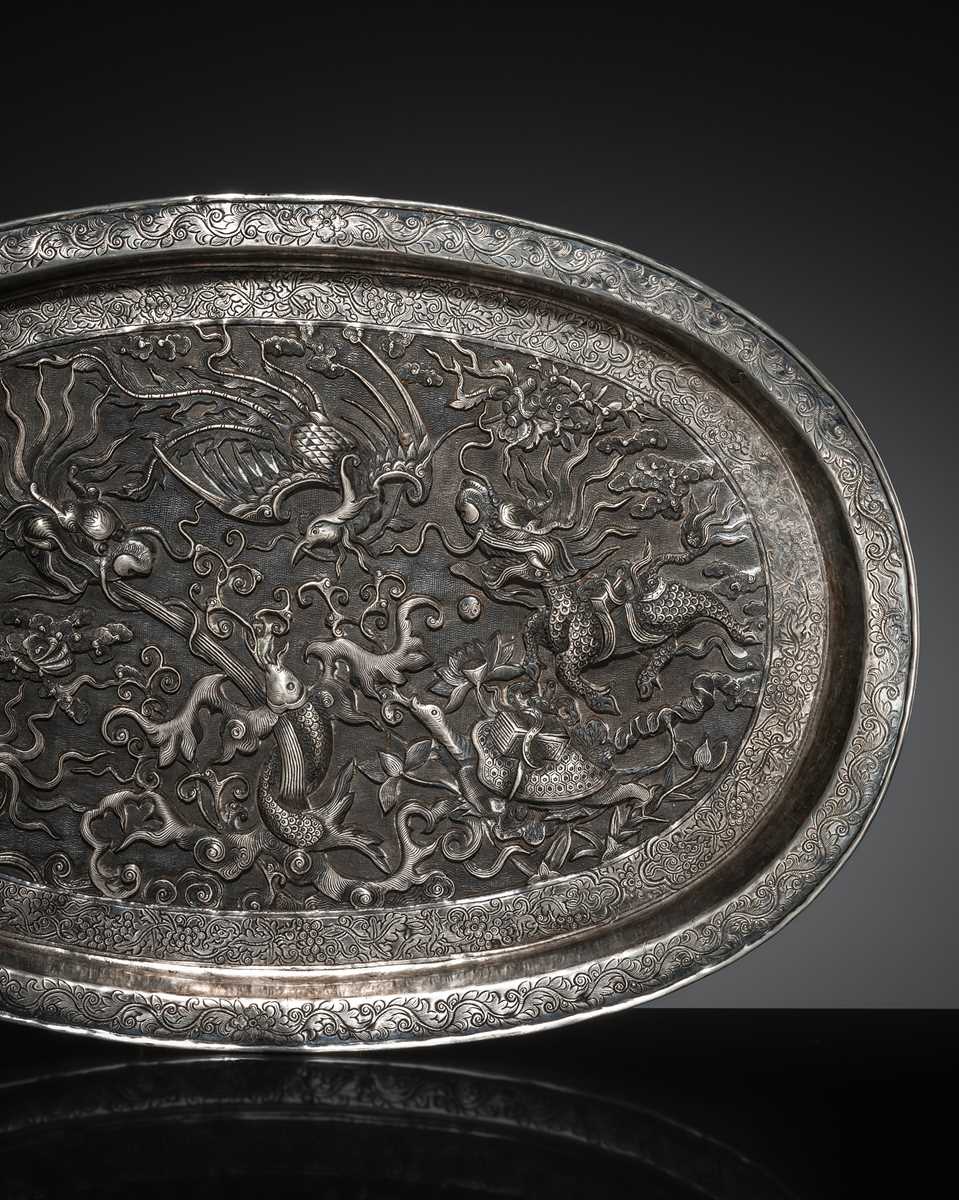 Lot 103 - A SILVER-REPOUSSÉ ‘FOUR SYMBOLS’ TRAY, SI XIANG, CHINA, 18TH-19TH CENTURY OR EARLIER