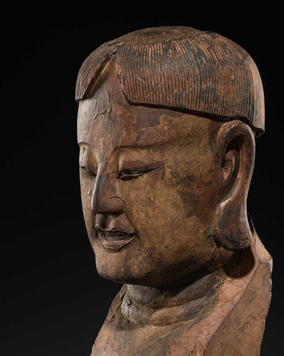 Lot 105 - A CARVED WOOD HEAD OF A BUDDHIST DISCIPLE, LATE MING TO EARLY QING DYNASTY
