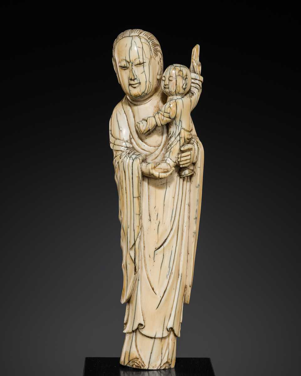 Lot 108 - AN IVORY FIGURE OF SONGZI GUANYIN AND CHILD, LATE MING DYNASTY