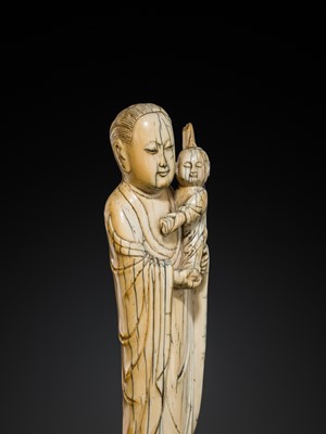 Lot 108 - AN IVORY FIGURE OF SONGZI GUANYIN AND CHILD, LATE MING DYNASTY
