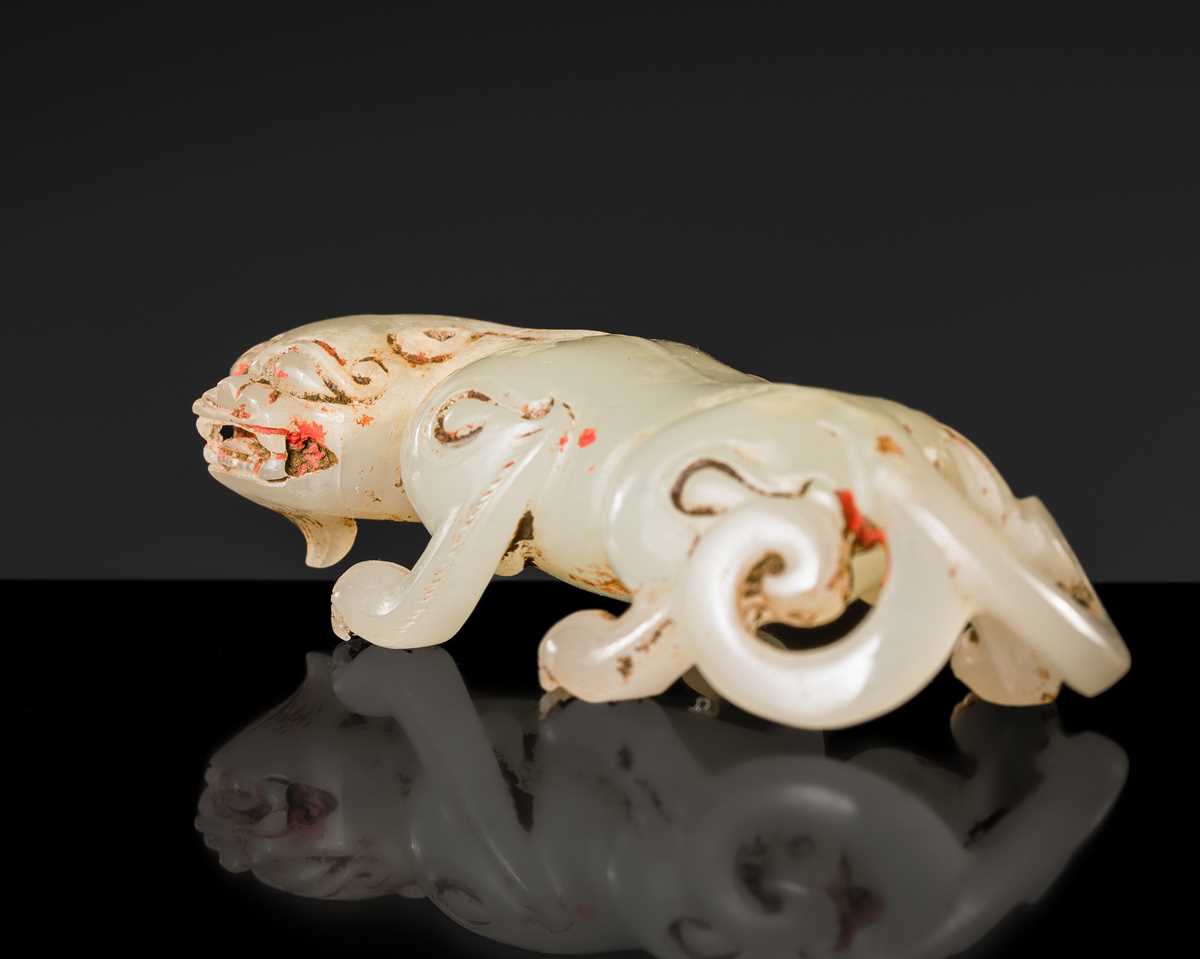 Lot 100 - A SMALL PALE CELADON JADE FIGURE OF A CHILONG, 17TH CENTURY OR EARLIER