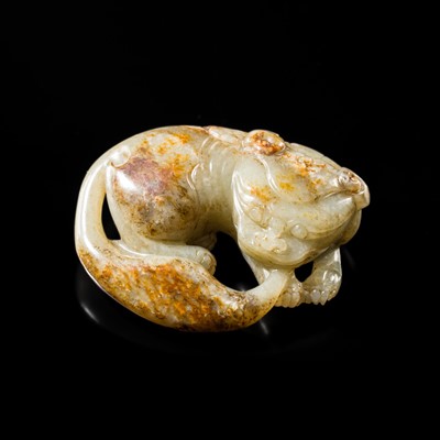 Lot 248 - A CELADON AND RUSSET CARVING OF A BUDDHIST LION, MING DYNASTY