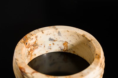Lot 95 - A YELLOW AND RUSSET JADE ‘ROPE-TWIST’ BANGLE, HAN DYNASTY OR EARLIER