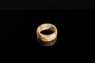 Lot 95 - A YELLOW AND RUSSET JADE ‘ROPE-TWIST’ BANGLE, HAN DYNASTY OR EARLIER