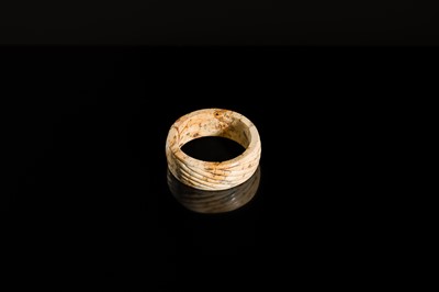 Lot 95 - A YELLOW AND RUSSET JADE ‘ROPE-TWIST’ BANGLE, HAN DYNASTY OR EARLIER